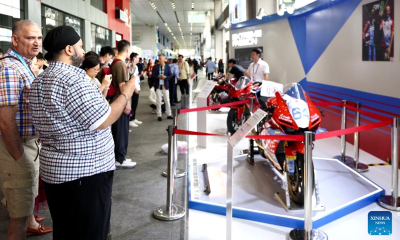 Visitors look at products of Chinese motorcycle maker ZXMOTO at the 139th edition of the China Import and Export Fair in Guangzhou, south China's Guangdong Province, April 17, 2026. The recent historic double victory by Chinese motorcycle maker ZXMOTO in the World Supersport category at the Portuguese round of the Superbike World Championship has drawn widespread attention. (Xinhua/Lu Hanxin)

