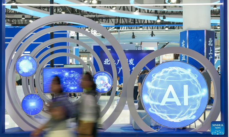 People walk past an AI-themed installation during the sixth China International Consumer Products Expo (CICPE) in Haikou, south China's Hainan Province, April 14, 2026. The ongoing sixth CICPE features groundbreaking innovations in artificial intelligence (AI). A wide range of new tech consumer products are showcased at the event, spanning multiple sectors including smart interaction, wearable devices, and smart healthcare. (Xinhua/Xin Yuewei)