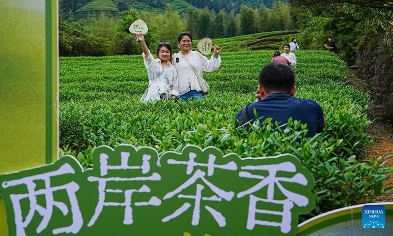 Tourists pose for photos during a cultural event at a tea garden in Xingcun Town, Wuyishan, southeast China's Fujian Province, April 15, 2026. (Photo by Chen Ying/Xinhua)