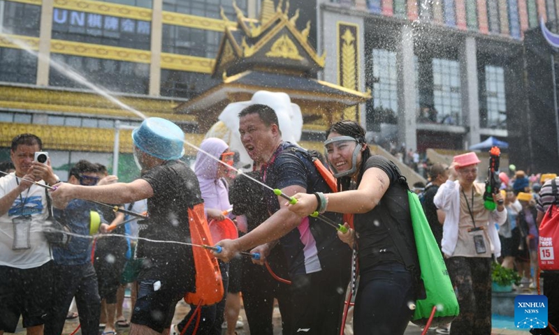 People celebrate the water-splashing festival at a square in Jinghong, Xishuangbanna Dai Autonomous Prefecture, southwest China's Yunnan Province, April 15, 2026. The water-splashing festival is regarded as one of the most important festivals of ethnic groups in southwest China. During the festival, water is considered an auspicious symbol and people splash water on one another, thereby wishing happiness and good fortune. (Xinhua/Jiang Wenyao)

