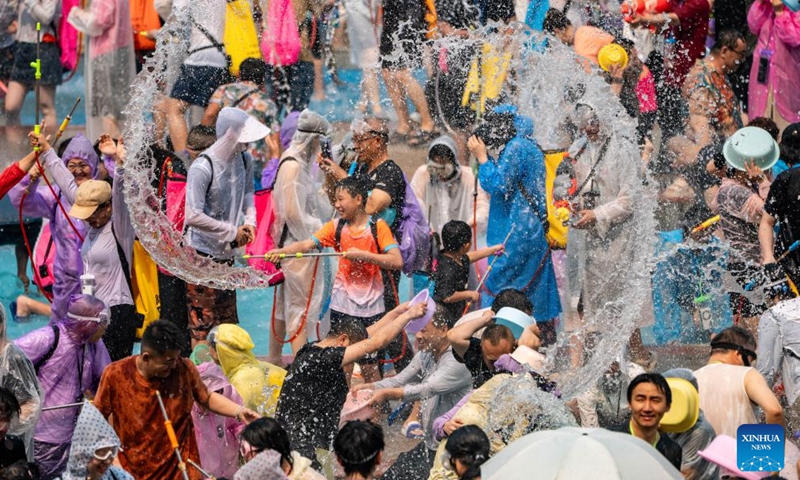 People celebrate the water-splashing festival at a square in Jinghong, Xishuangbanna Dai Autonomous Prefecture, southwest China's Yunnan Province, April 15, 2026. The water-splashing festival is regarded as one of the most important festivals of ethnic groups in southwest China. During the festival, water is considered an auspicious symbol and people splash water on one another, thereby wishing happiness and good fortune. (Xinhua/Jiang Wenyao)

