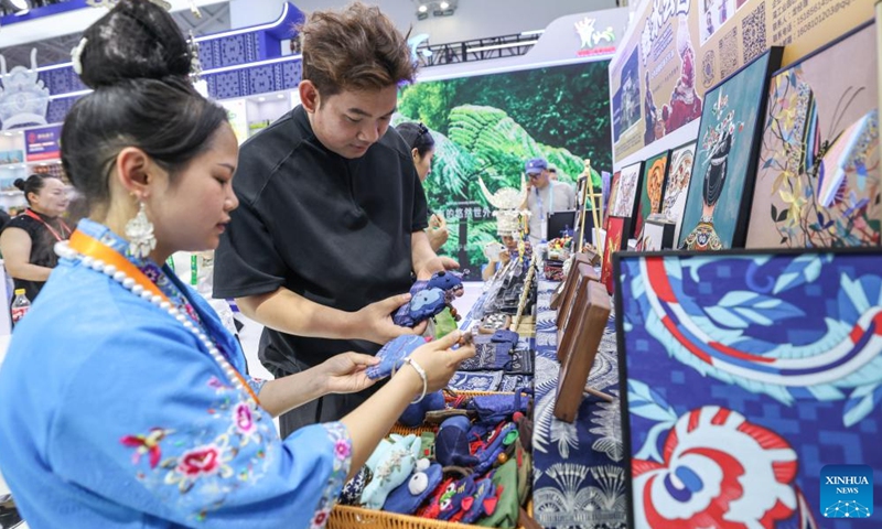 People look at Miao embroidery works during the sixth China International Consumer Products Expo (CICPE) in Haikou, south China's Hainan Province, April 14, 2026. From intangible cultural heritage skills to original IPs with traditional Chinese cultural characteristics, Chinese brands blend tradition with modernity and showcase their charm at the ongoing CICPE, attracting the attention of many visitors. (Xinhua/Zhang Liyun)