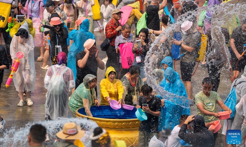 People celebrate the water-splashing festival at a square in Jinghong, Xishuangbanna Dai Autonomous Prefecture, southwest China's Yunnan Province, April 15, 2026. The water-splashing festival is regarded as one of the most important festivals of ethnic groups in southwest China. During the festival, water is considered an auspicious symbol and people splash water on one another, thereby wishing happiness and good fortune. (Xinhua/Jiang Wenyao)

