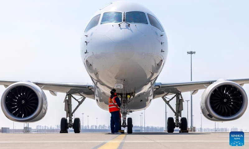 A ground crew member works at Harbin Taiping International Airport in Harbin, northeast China's Heilongjiang Province, April 15, 2026. The flight MU5631 carrying 140 passengers landed in Harbin on Wednesday, marking a successful maiden flight of C919, China's homegrown large passenger aircraft, on the Harbin-Shanghai route of China Eastern Airlines. (Xinhua/Zhang Tao)

