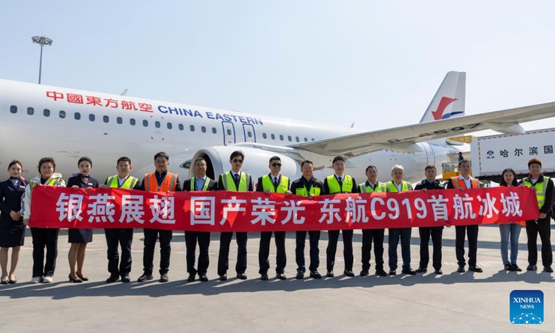 Staff members pose for a memorial group photo at Harbin Taiping International Airport in Harbin, northeast China's Heilongjiang Province, April 15, 2026. The flight MU5631 carrying 140 passengers landed in Harbin on Wednesday, marking a successful maiden flight of C919, China's homegrown large passenger aircraft, on the Harbin-Shanghai route of China Eastern Airlines. (Xinhua/Zhang Tao)

