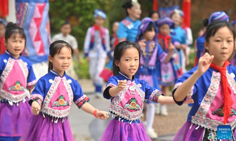 Students dance at a primary school in Changzhou District of Wuzhou City, south China's Guangxi Zhuang Autonomous Region, April 15, 2026. The Sanyuesan Festival is a traditional festival celebrated on the third day of the third lunar month by various ethnic groups in China, which falls on April 19 this year. (Xinhua/Huang Xiaobang)