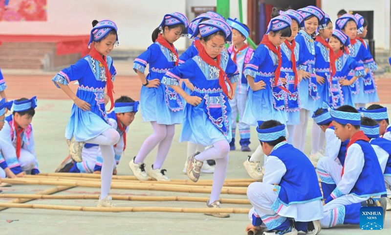 Students perform bamboo pole dance at a primary school in Changzhou District of Wuzhou City, south China's Guangxi Zhuang Autonomous Region, April 15, 2026. The Sanyuesan Festival is a traditional festival celebrated on the third day of the third lunar month by various ethnic groups in China, which falls on April 19 this year. (Xinhua/Huang Xiaobang)