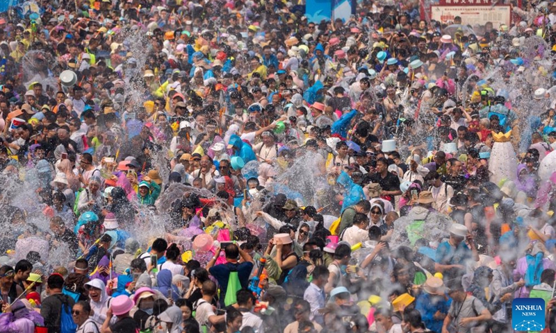 People celebrate the water-splashing festival at a square in Jinghong, Xishuangbanna Dai Autonomous Prefecture, southwest China's Yunnan Province, April 15, 2026. The water-splashing festival is regarded as one of the most important festivals of ethnic groups in southwest China. During the festival, water is considered an auspicious symbol and people splash water on one another, thereby wishing happiness and good fortune. (Xinhua/Jiang Wenyao)

