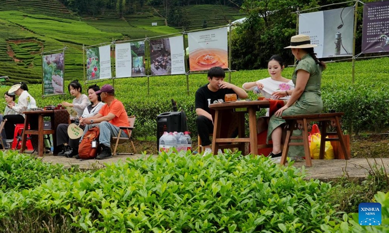 People taste tea during a cultural event at a tea garden in Xingcun Town, Wuyishan, southeast China's Fujian Province, April 15, 2026. (Photo by Chen Ying/Xinhua)