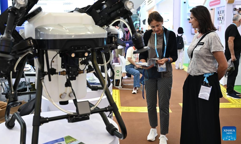 International buyers look at a plant protection drone at the 139th edition of the China Import and Export Fair in Guangzhou, south China's Guangdong Province, April 15, 2026. The 139th edition of the China Import and Export Fair, also known as the Canton Fair, opened here on Wednesday, drawing a record number of over 32,000 participating enterprises. (Xinhua/Deng Hua)

