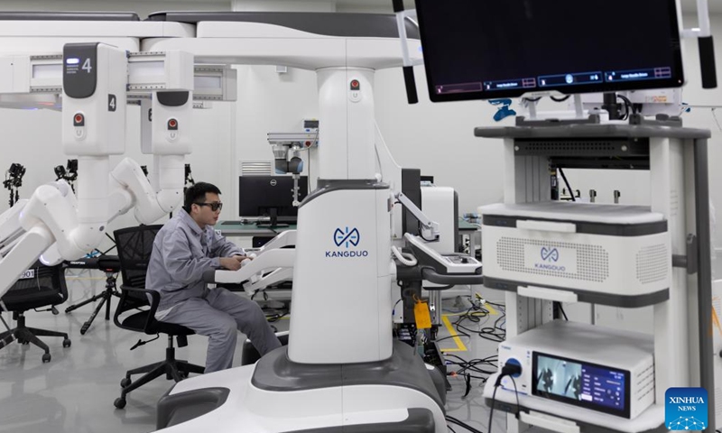 A technician debugs equipment at Harbin Sagebot Intelligent Medical Equipment Co., Ltd. in Harbin, northeast China's Heilongjiang Province, April 16, 2026. In recent years, the Harbin-based medical equipment enterprise has been dedicated to the development of high-end medical equipment as well as core technologies in surgical robots. Their robots have performed over 10,000 successful clinical surgeries worldwide, covering key departments including general surgery, urology, gynaecology, and thoracic surgery. (Xinhua/Zhang Tao)

