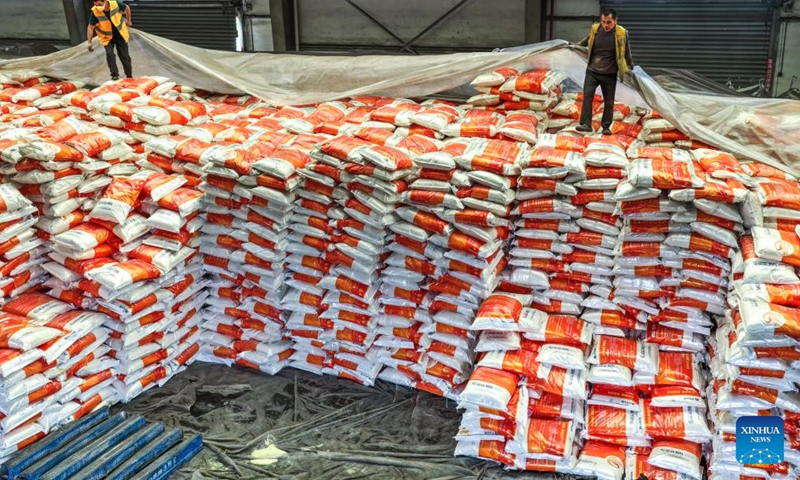 Workers cover fertilizer with films at a store of the Niuchang Railway Station on Weng'an-Machangping Railway in southwest China's Guizhou Province, April 16, 2026.

