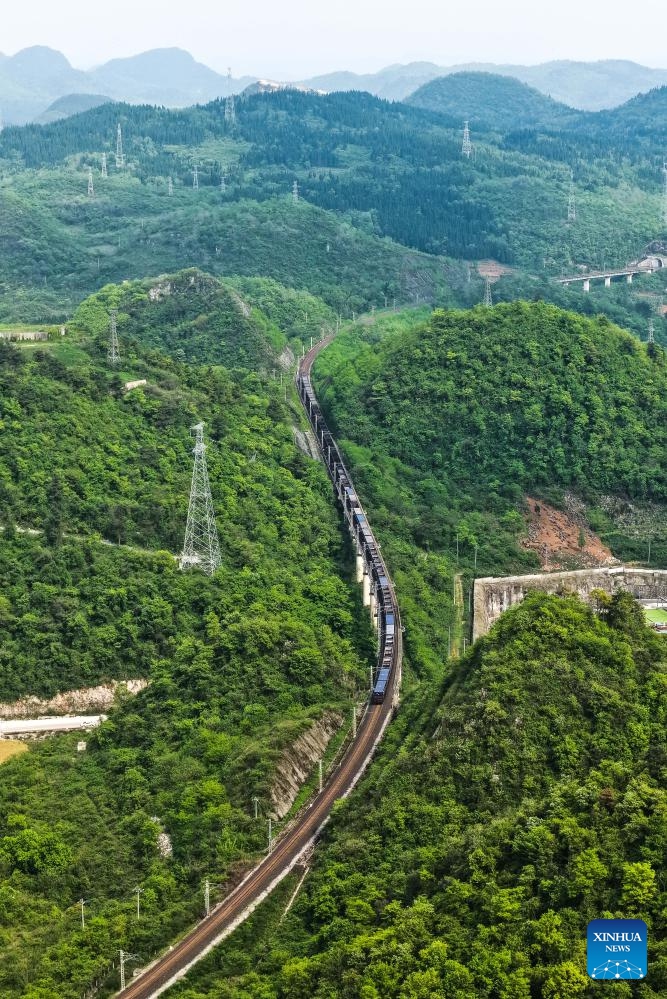 A drone photo taken on April 16, 2026 shows a train loaded with raw materials of fertilizer running on Weng'an-Machangping Railway in southwest China's Guizhou Province.


