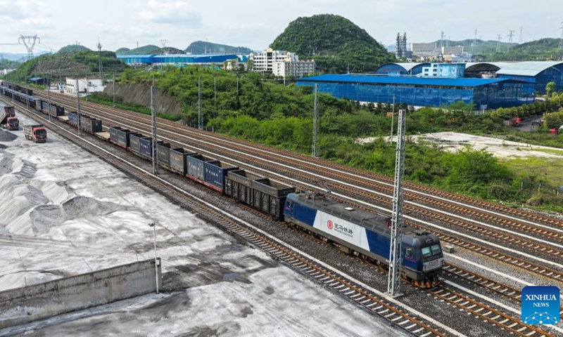 A drone photo taken on April 16, 2026 shows a train loaded with agricultural materials at Niuchang Railway Station on Weng'an-Machangping Railway in southwest China's Guizhou Province.

