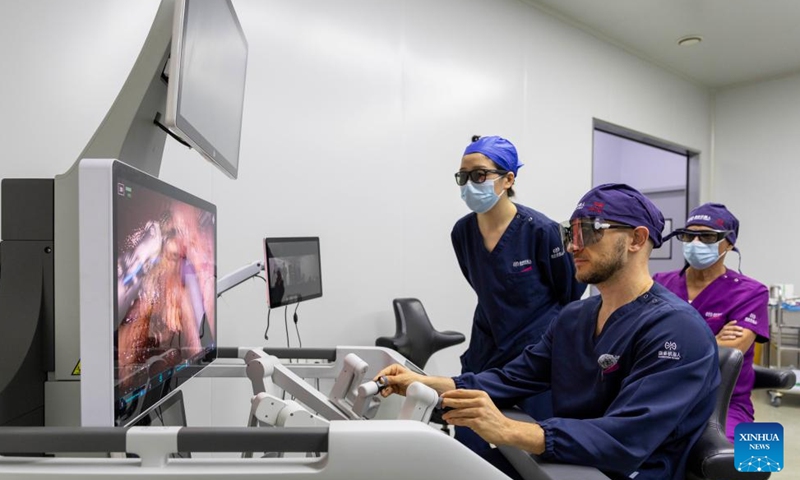A foreign doctor operates a surgery simulator at the surgical innovation and training center of Harbin Sagebot Intelligent Medical Equipment Co., Ltd. in Harbin, northeast China's Heilongjiang Province, April 16, 2026. In recent years, the Harbin-based medical equipment enterprise has been dedicated to the development of high-end medical equipment as well as core technologies in surgical robots. Their robots have performed over 10,000 successful clinical surgeries worldwide, covering key departments including general surgery, urology, gynaecology, and thoracic surgery. (Xinhua/Zhang Tao)

