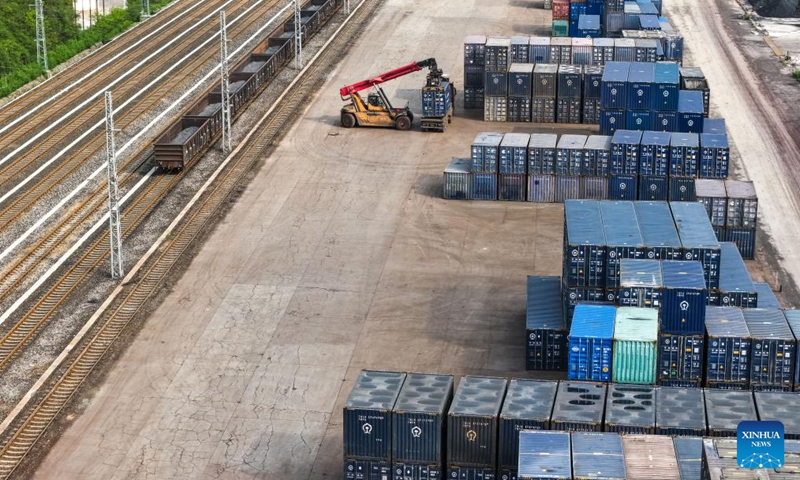 A drone photo taken on April 16, 2026 shows workers transferring raw materials of fertilizer at Niuchang Railway Station on Weng'an-Machangping Railway in southwest China's Guizhou Province.

