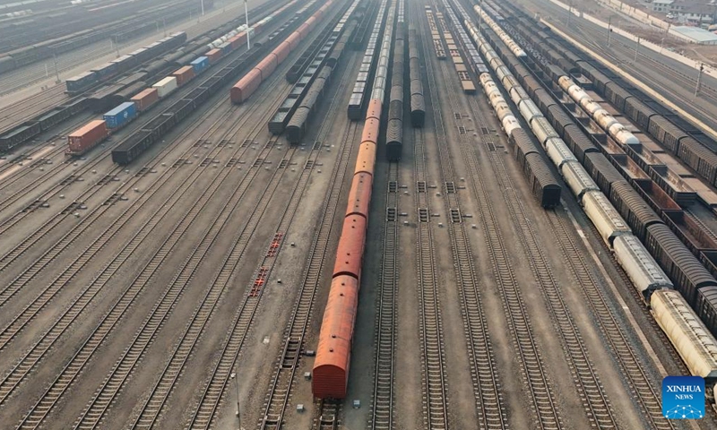 An aerial drone photo taken on March 17, 2026 shows freight trains carrying materials for spring farming at Harbin South Railway Station in Harbin, northeast China's Heilongjiang Province.

