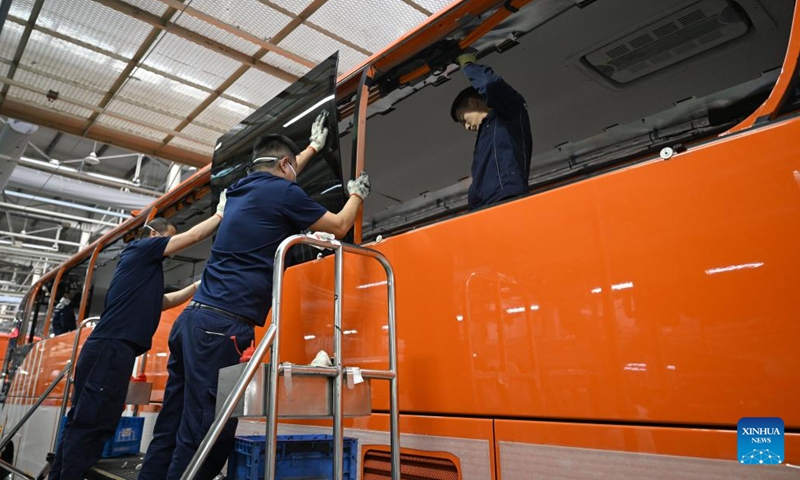 Staff members work on a production line at a factory of Yutong Group in Zhengzhou, central China's Henan Province, March 30, 2026.


