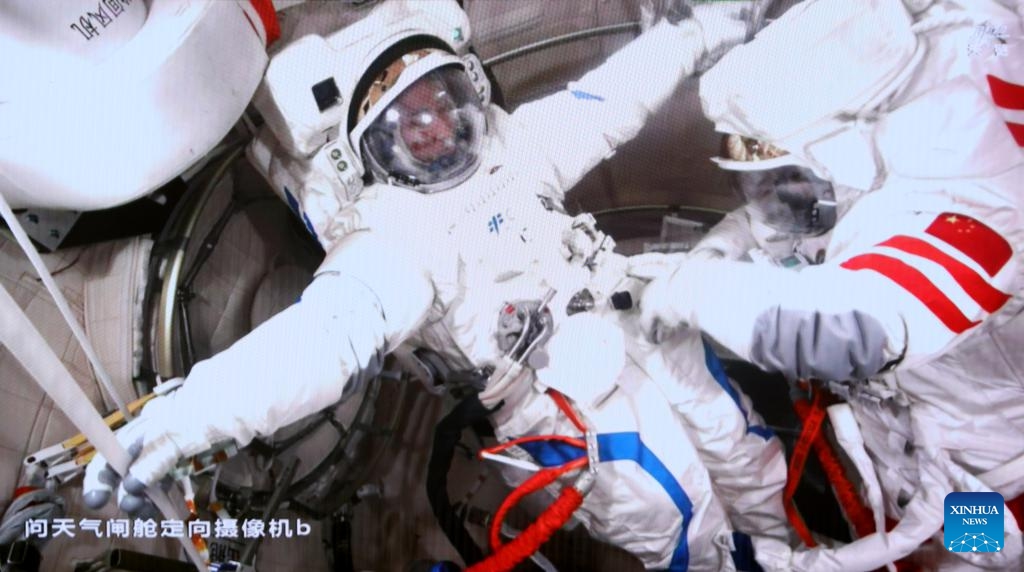 This screen image captured at Beijing Aerospace Control Center on April 16, 2026 shows Shenzhou-21 taikonauts Wu Fei (L) and Zhang Lu preparing to perform extravehicular activities (EVAs) outside China's orbiting space station. (Photo by Zhang Fan/Xinhua)