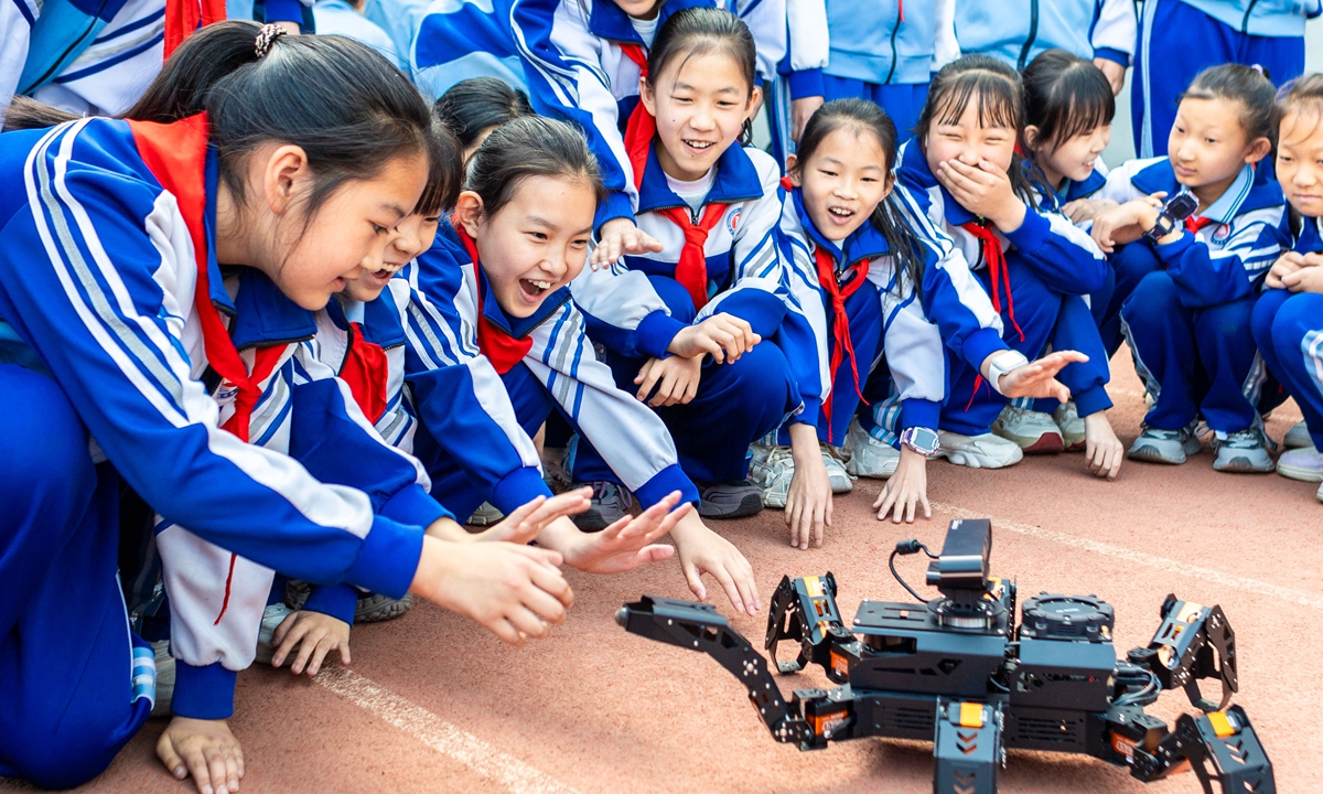 Students interact with hexapod robots at the first campus science and technology festival of a primary school in Hohhot, North China's Inner Mongolia Autonomous Region, on April 17, 2026. Photo: VCG