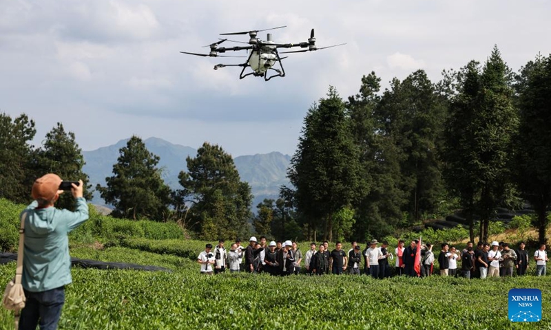 Trainees learn the operation of agricultural drone at a tea garden in Baicha Village of Yundong Town, Duyun City of Qiannan Bouyei and Miao Autonomous Prefecture, southwest China's Guizhou Province, April 17, 2026. Trainees on an agricultural drone application training course in Guizhou Province took part in practical exercises in Duyun City on Friday to improve their skills in operating crop protection drones. (Xinhua/Yang Wenbin)