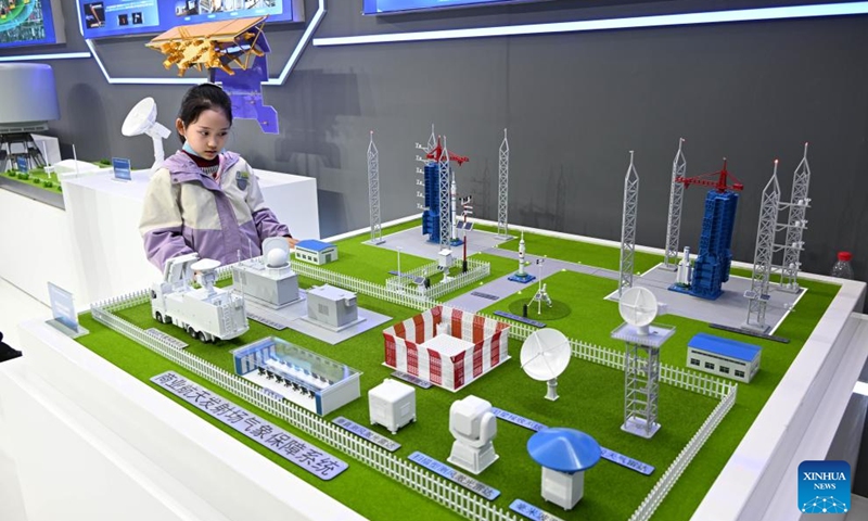 A girl views a sand table of a meteorological support system for space launch sites during the 6th Radar Future Conference in Qingdao, east China's Shandong Province, on April 18, 2026. The conference opened here on Saturday and will run till April 20, showcasing the latest radar-related technologies and products. (Xinhua/Li Ziheng)