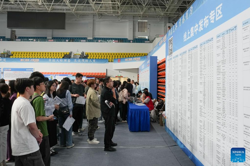 Job seekers checks job vacancy information at a job fair held at Hunan Normal University in Changsha, central China's Hunan Province, April 18, 2026. The two-day job fair for university graduates kicked off on Saturday, with the main venues in Hunan University and Hunan Normal University. (Xinhua/Chen Zhenhai)