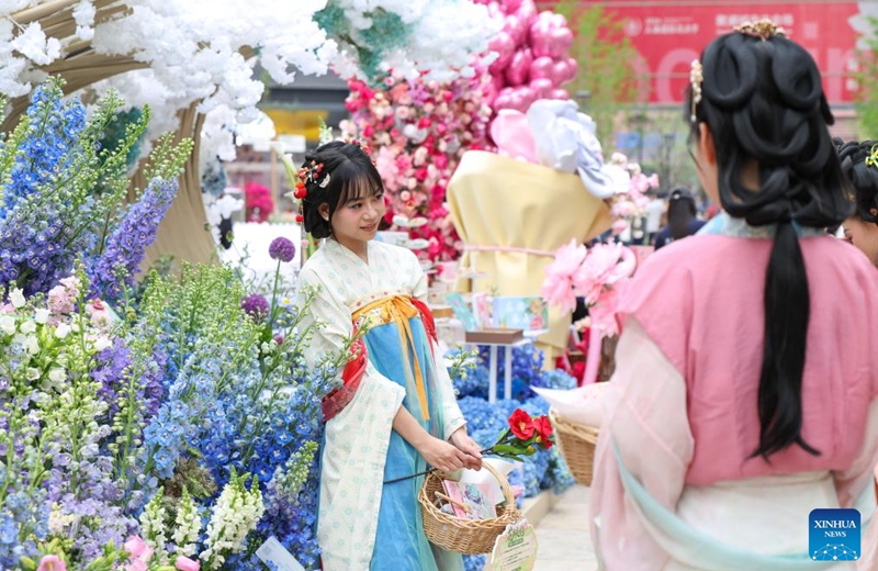 Staff members take photos at a flower fair in Huangpu District of Shanghai, east China, April 18, 2026. The 2026 Shanghai International Flower Show opened on Saturday with events in two main venues, 10 sub-venues and multiple exhibition spots across the city. (Xinhua/Chen Haoming)