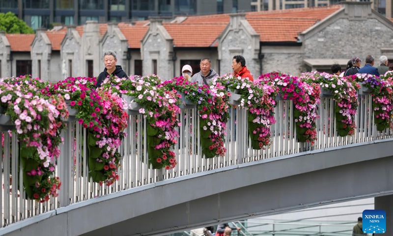 People visit a flower fair in Jing'an District of Shanghai, east China, April 18, 2026. The 2026 Shanghai International Flower Show opened on Saturday with events in two main venues, 10 sub-venues and multiple exhibition spots across the city. (Xinhua/Wang Xiang)