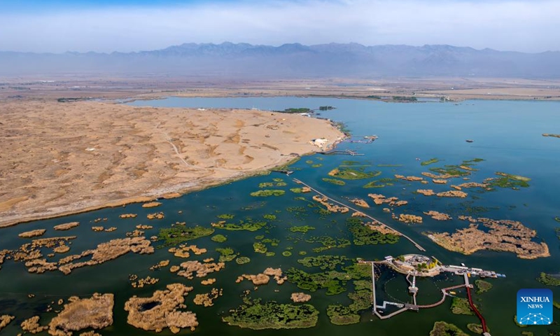 An aerial drone photo taken on April 18, 2026 shows the Shahu scenic area in Pingluo County of Shizuishan City in northwest China's Ningxia Hui Autonomous Region. From March to October each year, the Shahu scenic area serves as an important breeding habitat for migratory birds, featuring vast expanses of water, abundant plankton, fish and shrimp, and a variety of ecosystems.

In recent years, the area has continuously advanced the systematic governance of mountains, rivers, forests, farmlands, lakes, grasslands and deserts, restored lakes previously used for aquaculture, converted farmlands back into wetlands, and improved both water quality and the overall ecological environment. The number of birds species in the area has grown from 178 in 2011 to 216. Photo: Xinhua