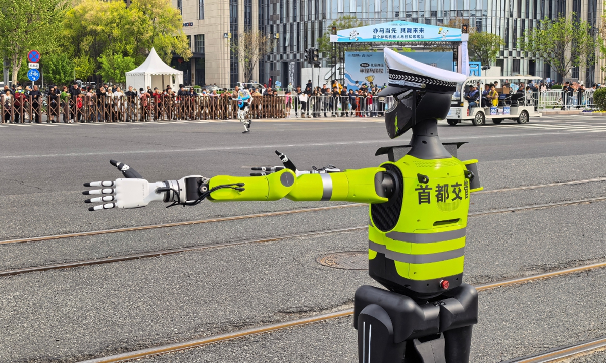 Beijing traffic police robot makes a debut at humanoid robot half-marathon run