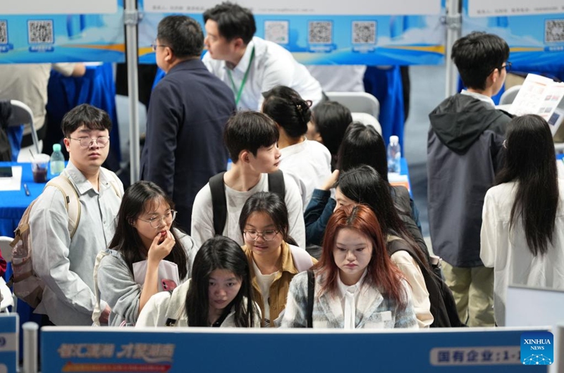 Job seekers checks job vacancy information at a job fair held at Hunan Normal University in Changsha, central China's Hunan Province, April 18, 2026. The two-day job fair for university graduates kicked off on Saturday, with the main venues in Hunan University and Hunan Normal University. (Xinhua/Chen Zhenhai)