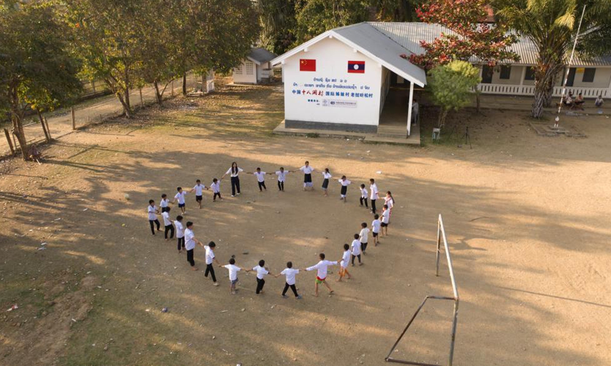 Students play on the playground at a kindergarten in Tingsong Village in Laos. Photo: Xinhua