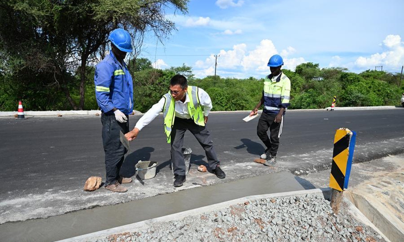 This photo taken on Dec. 7, 2025 shows construction workers carrying out road surface rehabilitation at the Matambo-Marara section of National Road 301 in Tete city, Mozambique. (China Henan International Cooperation Group/Handout via Xinhua)