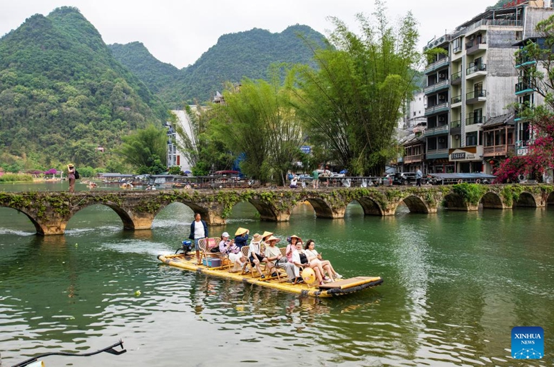 Tourists take a bamboo raft tour in the Equan scenic spot of Jingxi City, south China's Guangxi Zhuang Autonomous Region, April 17, 2026. (Photo by Zhao Jingwu/Xinhua)