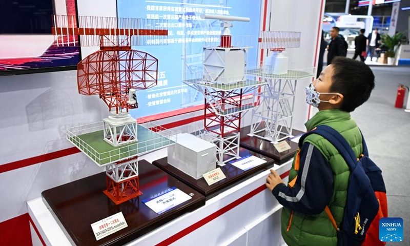 A boy views models of radars for air traffic control during the 6th Radar Future Conference in Qingdao, east China's Shandong Province, on April 18, 2026. The conference opened here on Saturday and will run till April 20, showcasing the latest radar-related technologies and products. (Xinhua/Li Ziheng)