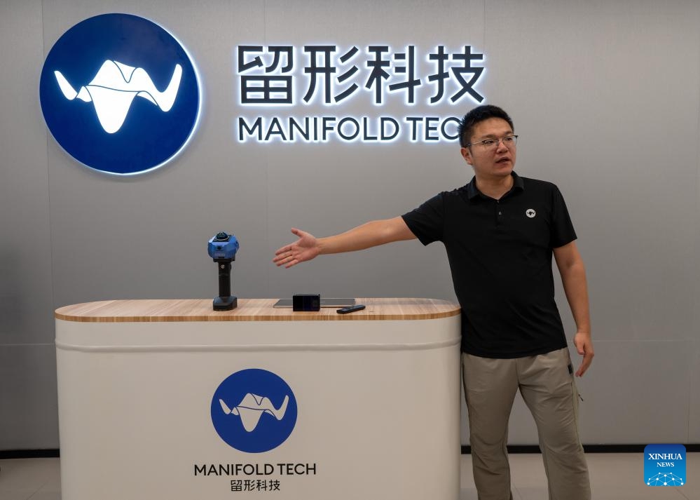 Xu Wei, co-founder of Manifold Tech, introduces a product of his company at the Qianhai Shenzhen-Hong Kong Youth Innovation and Entrepreneur Hub in Shenzhen, south China's Guangdong Province, March 28, 2026. (Xinhua/Liu Mengqi)

