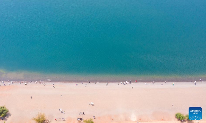 An aerial drone photo taken on April 18, 2026 shows a view of the Fuxian Lake in Yuxi City, southwest China's Yunnan Province. Fuxian Lake stretches out like a sapphire cradled by hills. It boasts Class I water quality, while its shores are now lined with bike paths and dotted with kayaks. (Xinhua/Peng Yikai)

