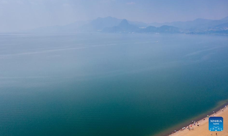 An aerial drone photo taken on April 18, 2026 shows a view of the Fuxian Lake in Yuxi City, southwest China's Yunnan Province. Fuxian Lake stretches out like a sapphire cradled by hills. It boasts Class I water quality, while its shores are now lined with bike paths and dotted with kayaks. (Xinhua/Peng Yikai)

