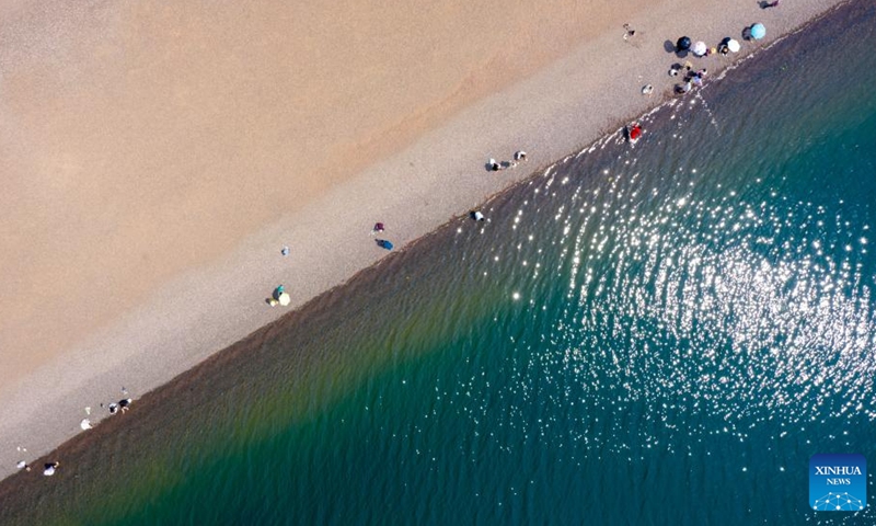An aerial drone photo taken on April 18, 2026 shows a view of the Fuxian Lake in Yuxi City, southwest China's Yunnan Province. Fuxian Lake stretches out like a sapphire cradled by hills. It boasts Class I water quality, while its shores are now lined with bike paths and dotted with kayaks. (Xinhua/Peng Yikai)

