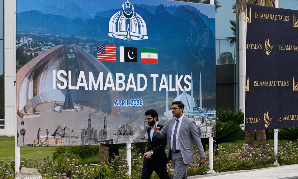 People walk past the press center for the talks between the United States and Iran in Islamabad, Pakistan, April 11, 2026. Photo: Xinhua