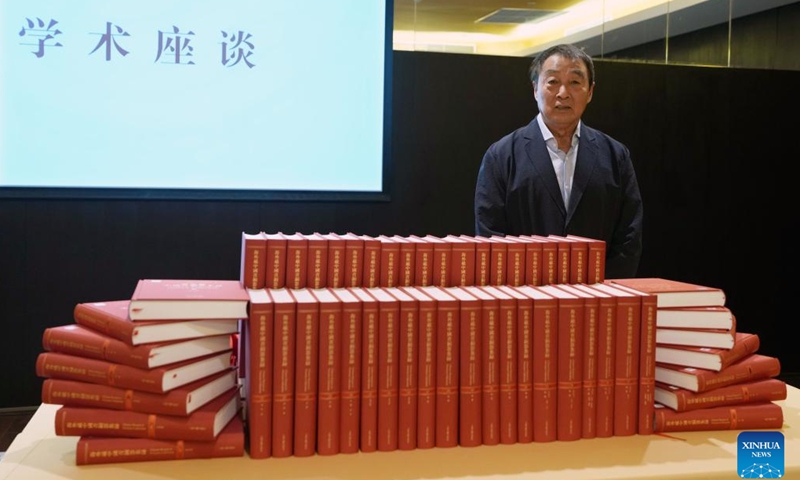 Professor Zhu Fenghan, the lead editor of a sixty-volume compendium documenting more than 23,000 ancient Chinese bronze artifacts lost abroad, poses for a photo during a press conference for the books' release in east China's Shanghai, April 19, 2026. (Xinhua/Liu Ying)

