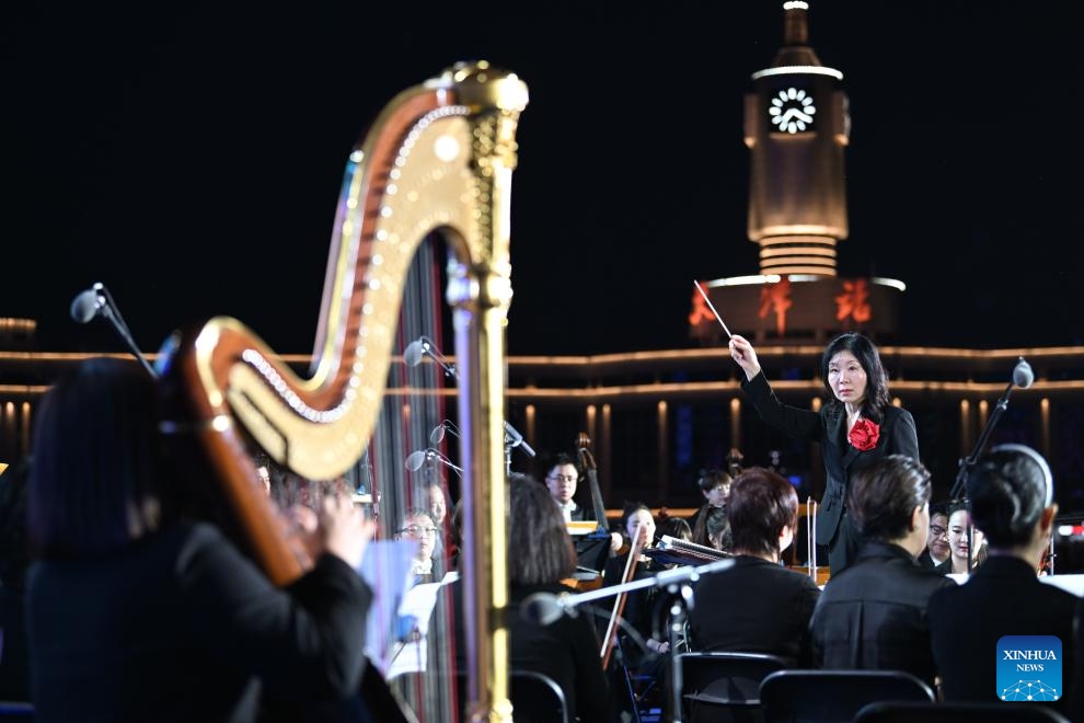 Members of Tianjin Symphony Orchestra perform at the Jinwan Square by the Haihe River in north China's Tianjin, April 18, 2026. 