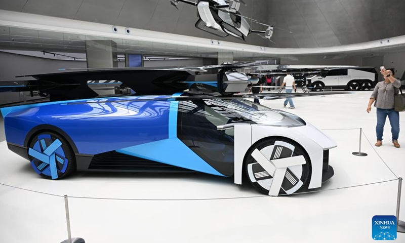 Visitors view vehicles displayed at Xpeng Technology Park in Tianhe District of Guangzhou, south China's Guangdong Province on March 24, 2026.

