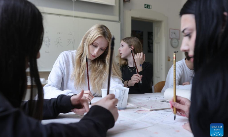 Students participate in a Chinese calligraphy workshop during an event marking the International Chinese Language Day at a high school in Celje, Slovenia, April 20, 2026. (Photo by Zeljko Stevanic/Xinhua)

