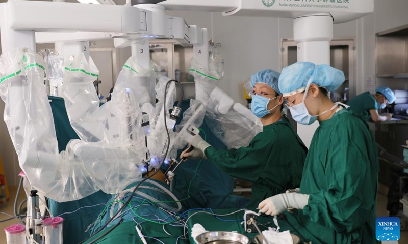 Doctors perform surgery on a patient at Tianjin Medical University Cancer Institute & Hospital in Tianjin, north China, April 19, 2026. In recent years, Tianjin Medical University Cancer Institute & Hospital has continued to advance its expertise in minimally invasive surgery. The hospital currently has three da Vinci surgical robots and has performed over 10,000 surgeries with the system, establishing a multidisciplinary minimally invasive treatment system. (Xinhua/Li Ran)

