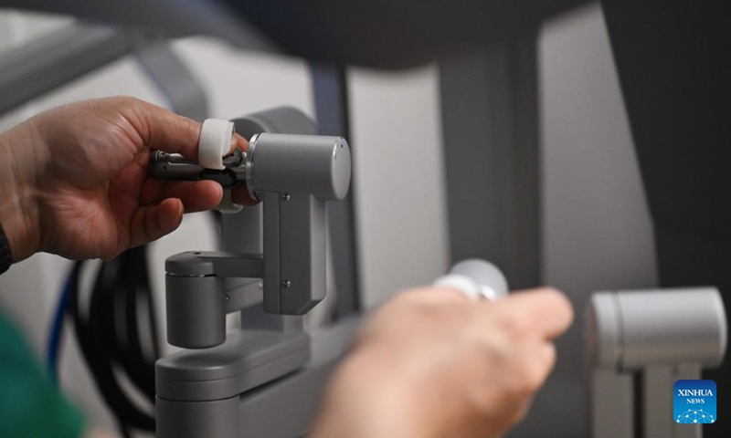 A doctor operates a da Vinci surgical robot at Tianjin Medical University Cancer Institute & Hospital in Tianjin, north China, April 19, 2026. In recent years, Tianjin Medical University Cancer Institute & Hospital has continued to advance its expertise in minimally invasive surgery. The hospital currently has three da Vinci surgical robots and has performed over 10,000 surgeries with the system, establishing a multidisciplinary minimally invasive treatment system. (Xinhua/Li Ran)

