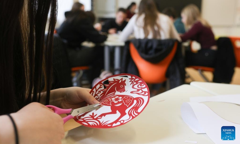 Students participate in a paper-cutting workshop during an event marking the International Chinese Language Day at a high school in Celje, Slovenia, April 20, 2026. (Photo by Zeljko Stevanic/Xinhua)


