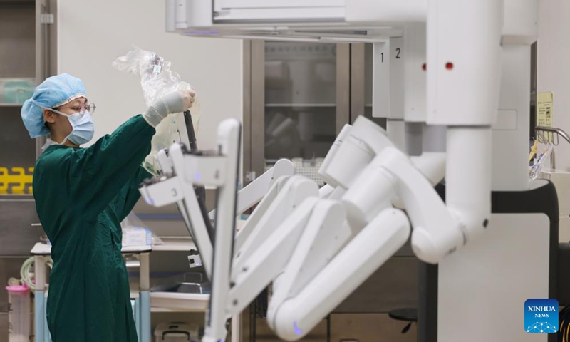 A doctor conducts preoperative preparation at Tianjin Medical University Cancer Institute & Hospital in Tianjin, north China, April 19, 2026. In recent years, Tianjin Medical University Cancer Institute & Hospital has continued to advance its expertise in minimally invasive surgery. The hospital currently has three da Vinci surgical robots and has performed over 10,000 surgeries with the system, establishing a multidisciplinary minimally invasive treatment system. (Xinhua/Li Ran)

