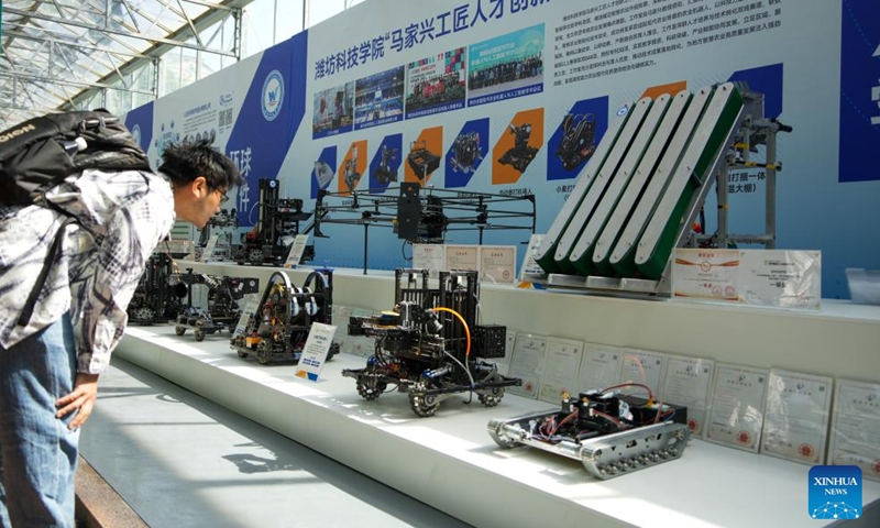 A visitor learns about agricultural robots at the 27th China (Shouguang) International Vegetable Science and Technology Expo in Shouguang, east China's Shandong Province, April 20, 2026.

